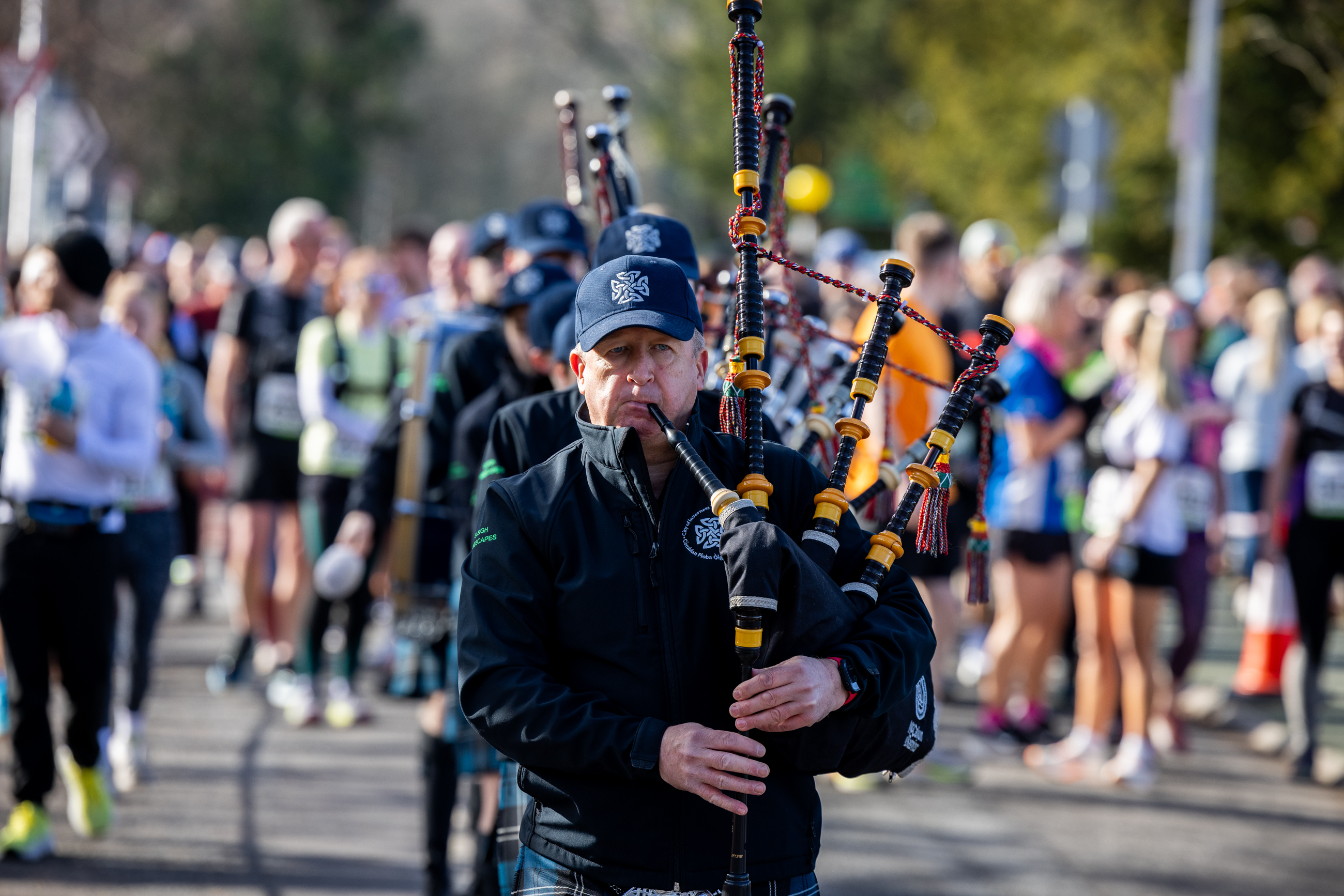 Bagpiper plays to Inverness Half participants 