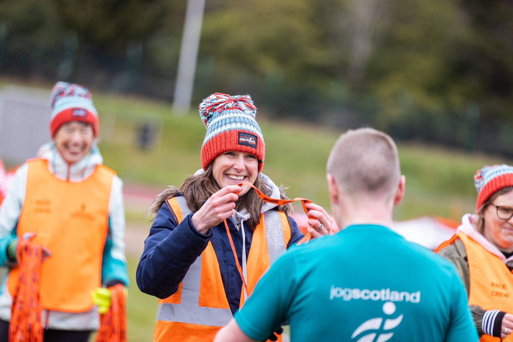 Volunteers handing out medals at Inverness Half Marathon