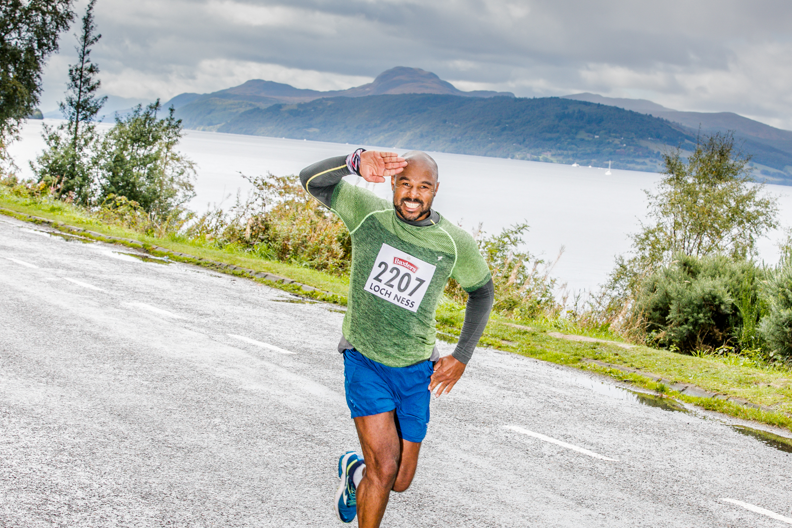Loch Ness Marathon runner salutes the camera on their way round