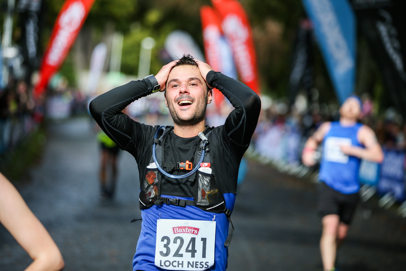 Runner with their head in their hands at the Finish Line